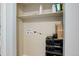 Utility closet with shelves and hookups for a washer and dryer at 1585 S Holly St # 109, Denver, CO 80222