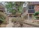 Charming exterior view showcasing the community's landscaped walkways and inviting building design at 1585 S Holly St # 109, Denver, CO 80222