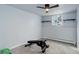 Gym space featuring bench, window, baseboard heating, and overhead ceiling fan at 1585 S Holly St # 109, Denver, CO 80222