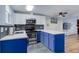 Beautiful kitchen with white countertops, blue cabinets, and stainless steel appliances at 1585 S Holly St # 109, Denver, CO 80222