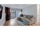 View of the living room with fireplace, gray couch, wood floors, and outdoor access at 1585 S Holly St # 109, Denver, CO 80222