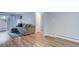 Bright living room featuring wood floors, a gray couch, and access to outdoor balcony at 1585 S Holly St # 109, Denver, CO 80222