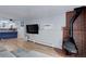 Open concept living room with wood flooring, a fireplace, kitchen, and a TV at 1585 S Holly St # 109, Denver, CO 80222