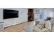 Comfortable living room with a fireplace, couch, wood flooring, and a TV at 1585 S Holly St # 109, Denver, CO 80222