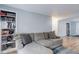 Bright living room featuring built-in bookshelves and comfortable seating area at 1585 S Holly St # 109, Denver, CO 80222