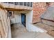 Patio space with brick wall, patio cover, and stairs at 1585 S Holly St # 109, Denver, CO 80222