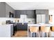 Bright kitchen with stainless steel appliances, white countertops, gray cabinets, and gold hardware at 351 S Lamar St, Lakewood, CO 80226