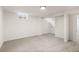 Spacious basement with neutral carpet, white walls, and a small window letting in natural light at 7555 E 22Nd Ave, Denver, CO 80207