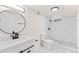 Bathroom featuring a modern vanity, round mirror, walk-in shower, and sleek black accents at 7555 E 22Nd Ave, Denver, CO 80207