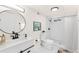 Bright bathroom with modern fixtures, white cabinets, sleek black accents, and a walk-in shower at 7555 E 22Nd Ave, Denver, CO 80207