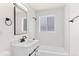 Contemporary all-white bathroom with updated fixtures and lighting at 7555 E 22Nd Ave, Denver, CO 80207