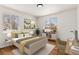 Cozy bedroom featuring stylish decor, comfortable bed, and a bright workspace at 7555 E 22Nd Ave, Denver, CO 80207