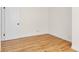 Empty bedroom showcasing hardwood floors, white walls, and natural light at 7555 E 22Nd Ave, Denver, CO 80207
