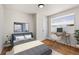 Relaxing bedroom featuring a work desk, stylish decor, and natural light at 7555 E 22Nd Ave, Denver, CO 80207