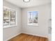 Bright dining area featuring hardwood floors and a large windows looking out on a snow covered yard at 7555 E 22Nd Ave, Denver, CO 80207
