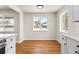Bright dining area featuring hardwood floors and a large windows looking out on a snow covered yard, next to the kitchen at 7555 E 22Nd Ave, Denver, CO 80207
