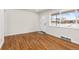 Bright entryway with hardwood floors, a white front door, and a large window view of the snow covered front yard at 7555 E 22Nd Ave, Denver, CO 80207
