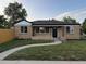 Charming brick home with a curved walkway, neat landscaping, and a well-maintained lawn at 7555 E 22Nd Ave, Denver, CO 80207
