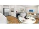 Bright, open kitchen with stainless steel appliances, hardwood floors, and a view into the living room at 7555 E 22Nd Ave, Denver, CO 80207