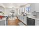 Well-lit kitchen featuring stainless steel appliances, quartz countertops, and white subway tile backsplash at 7555 E 22Nd Ave, Denver, CO 80207