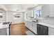 Bright kitchen featuring stainless steel appliances, quartz countertops, and white subway tile backsplash at 7555 E 22Nd Ave, Denver, CO 80207