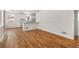 Spacious living room with hardwood floors, and an open view into the bright white kitchen at 7555 E 22Nd Ave, Denver, CO 80207