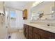 Bathroom with double sinks, a large mirror, and a shower-tub combination at 1791 S Laredo St, Aurora, CO 80017