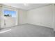 Minimalist bedroom featuring neutral carpet, a window, and empty space at 1791 S Laredo St, Aurora, CO 80017
