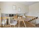 Upstairs dining nook with modern round table and adjacent railing overlooking the lower level at 1791 S Laredo St, Aurora, CO 80017