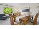 Bright dining room with wood table, modern art, and sunlit window at 1791 S Laredo St, Aurora, CO 80017