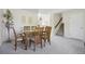 Open concept dining area featuring a wood table and view of the staircase at 1791 S Laredo St, Aurora, CO 80017