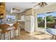 Inviting kitchen with breakfast bar, white refrigerator, and sliding door leading to outdoor space at 1791 S Laredo St, Aurora, CO 80017