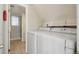 Functional laundry room with washer, dryer, and access to bathroom; convenient for chores and organization at 1791 S Laredo St, Aurora, CO 80017