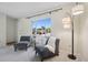 Cozy living area with armchairs, a floor lamp and a large, sunny window at 1791 S Laredo St, Aurora, CO 80017