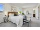 Bright main bedroom with a king bed, bench, and ample natural light from the window at 1791 S Laredo St, Aurora, CO 80017