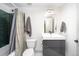 Modern bathroom with dark green tile and gray vanity at 2728 Macon Way, Denver, CO 80238