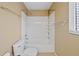 Clean, white bathroom features a bathtub and shower combination at 16256 E Otero Pl, Englewood, CO 80112