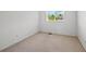 A basic, carpeted bedroom with a large window at 16256 E Otero Pl, Englewood, CO 80112