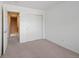 An additional bedroom with neutral colors, carpet, and sliding door closet at 16256 E Otero Pl, Englewood, CO 80112