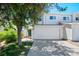 Inviting townhome with attached garage, mature shade tree and lush green lawn at 16256 E Otero Pl, Englewood, CO 80112