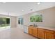 Bright kitchen boasts wood cabinets, double sinks, and a window with views of the outdoors at 16256 E Otero Pl, Englewood, CO 80112