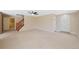 Spacious living room with neutral carpet, ceiling fan and staircase to second level at 16256 E Otero Pl, Englewood, CO 80112