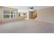 Bright, open-concept living room with neutral carpet, staircase and large window at 16256 E Otero Pl, Englewood, CO 80112