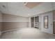 Finished basement area with carpeted floor, closet with shelves, and modern door with mirror at 3844 S Gibralter St, Aurora, CO 80013