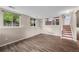 Finished basement area featuring hardwood floors, bright windows, and a staircase leading upstairs at 3844 S Gibralter St, Aurora, CO 80013