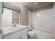 Classic bathroom featuring vanity sink, toilet, shower-tub, and large mirror at 3844 S Gibralter St, Aurora, CO 80013