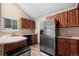 Eat in kitchen with stainless steel refrigerator, stainless steel appliances, and hardwood floors at 3844 S Gibralter St, Aurora, CO 80013