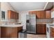 Eat in kitchen with stainless steel refrigerator, stainless steel appliances, and hardwood floors at 3844 S Gibralter St, Aurora, CO 80013