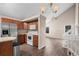 Open concept kitchen featuring stainless steel appliances and hardwood floors flowing into a spacious living area at 3844 S Gibralter St, Aurora, CO 80013