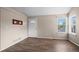 Bright living room with hardwood floors, fresh paint, and natural light from the large window at 3844 S Gibralter St, Aurora, CO 80013